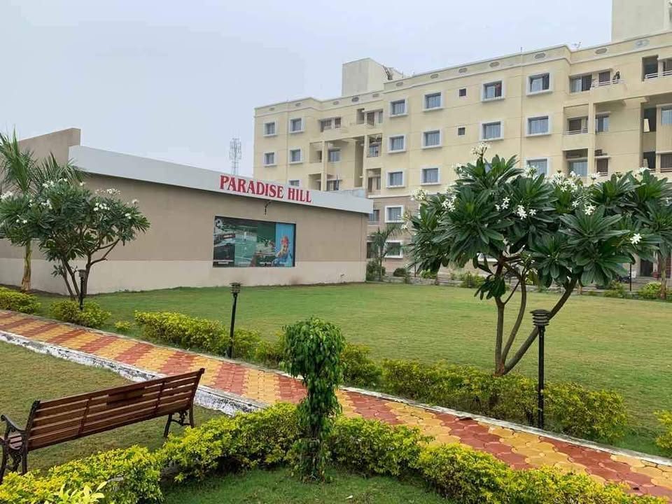 Paradise Hills clubhouse building with landscaped garden and walkway